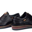 Pair of black leather shoes with visible brand logo on a white background