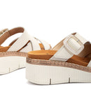 White sandals with brown soles on a white background