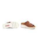 Brown sandals with a white sole on a white background, featuring the Pikolinos brand.