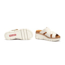 White sandals with brown sole and visible Pikolinos logo on a white background
