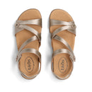 Pair of gold sandals with 'taos' branding on a white background