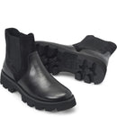 A pair of black Chelsea-style boots with a mix of smooth leather and textured mesh panels, featuring chunky lug soles, shown on a white background.