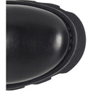 Close-up detail of a black leather boot toe cap with visible grain texture and a thick black sole edge on a white background.