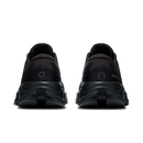 A pair of black athletic sneakers shown from the rear, featuring chunky sculpted soles and textured mesh uppers, set against a plain white background.