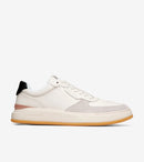 White sneaker with a brown sole on a white background