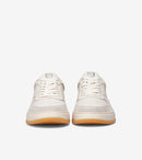 Pair of white sneakers with brown soles on a white background