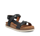 Black sandal with a brown sole on a white background