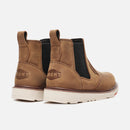 Pair of brown leather boots with a visible brand logo on a white background