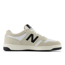 Beige sneaker with black 'N' logo on a white background