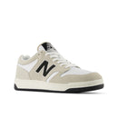Beige and white sneaker with black accents on a white background