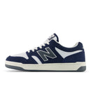 Navy and white sneaker with New Balance logo on a white background