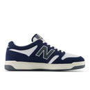 Navy and white sneaker with New Balance logo on a white background
