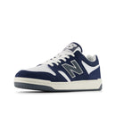 Navy and white sneaker with New Balance logo on a white background