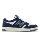 Navy and white sneaker with New Balance logo on a white background