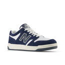 Navy and white sneaker with New Balance logo on a white background