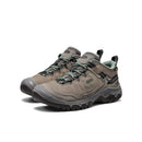 Pair of brown hiking shoes with green laces on a white background