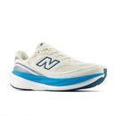 White running shoe with blue sole on a white background