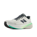 White running shoe with gray and green accents on a white background