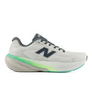 White running shoe with green sole on a white background