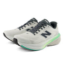 White running shoes with gray and green accents on a white background