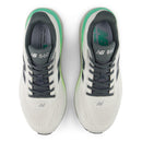 White running shoes with gray and green accents on a white background