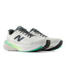 White running shoes with black and green accents on a white background