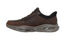 A dark brown and black low-top sneaker with a thick gray cushioned sole, shown in a side profile view against a plain white background.