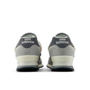 Gray New Balance sneakers shown from the back on a white background