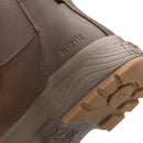 Close-up of the side and sole of a brown leather boot, showing the embossed brand name 'kizik' on the heel and a rugged tan outsole.