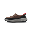 A side-profile view of a low-top slip-on shoe with a brown upper, black toe and heel sections, a thick gray midsole, and a small red accent lining the collar, set against a plain white background.