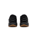 A pair of black Kizik sneakers shown from the rear, featuring a thick black sole with the Kizik brand name embossed and a brown gum outsole.