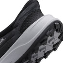 Close-up of a black and gray shoe with a brand logo on a white background