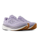Purple sneaker with brown sole on a white background