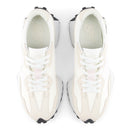 White sneakers with black soles on a white background