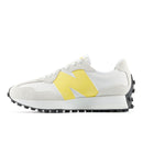 White sneaker with yellow accents on a white background