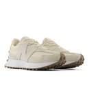 Pair of beige sneakers on a white background