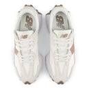 White sneakers with brown accents on a white background
