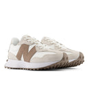 Pair of beige and brown sneakers on a white background