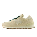 Beige sneaker with green laces on a white background