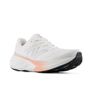 White running shoe with pink accent on a white background