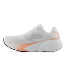 White and pink running shoe on a white background