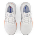 White running shoes with pink accents on a white background