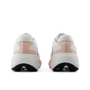 Pair of white and pink athletic shoes on a white background